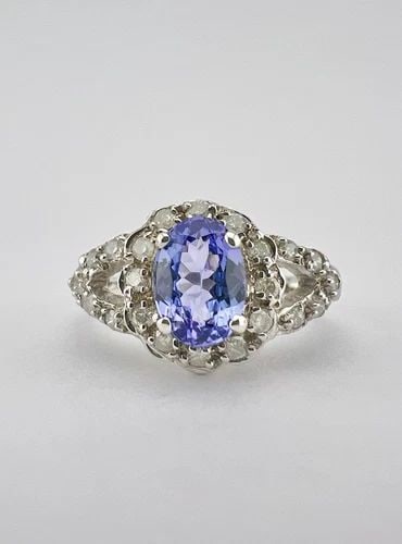 DESIGNER 14K WHITE GOLD .72CT OVAL TANZANITE & PAVE SET .28CT DIAMOND HALO RING: DESIGNER 14K WHITE GOLD .72CT OVAL TANZANITE & PAVE SET .28CT DIAMOND HALO RING Designer 14k White Gold .72ct Oval Tanzanite & Pave Set .28ct Diamond Halo Ring Ring Size: 6.25 - Can Be Resized Weight 