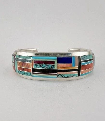 VTG WILBER YAZZIE STERLING SILVER MULTI GEMSTONE FLUSH INLAY CUFF BRACELET 65G: VTG WILBER YAZZIE STERLING SILVER MULTI GEMSTONE FLUSH INLAY CUFF BRACELET 65G Vtg Wilber Yazzie Sterling Silver Multi Gemstone Flush Inlay Cuff Bracelet 65g Cuff is 5 1/2" tip to Tip and has a 1 1/4"