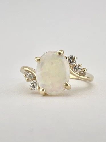 DESIGNER 14K YELLOW GOLD NATURAL AUSTRALIAN FIRE OPAL & VS DIAMOND BYPASS RING: DESIGNER 14K YELLOW GOLD NATURAL AUSTRALIAN FIRE OPAL & VS DIAMOND BYPASS RING Designer 14k Yellow Gold Natural Australian Fire Opal & VS Diamond Bypass Ring Size: 5.25 - Can Be Resized Metal: 14k Yel