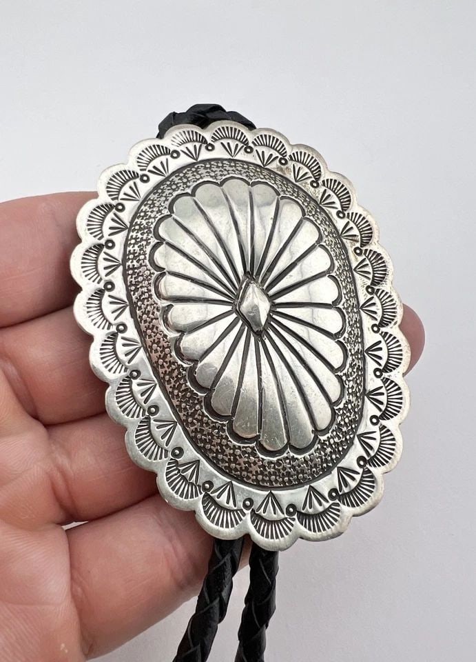 50.5G SUZZIE JAMES NAVAJO STERLING SILVER DEEP STAMPED OVAL CONCHO BOLO TIE 3": 50.5G SUZZIE JAMES NAVAJO STERLING SILVER DEEP STAMPED OVAL CONCHO BOLO TIE 3" Vintage 50.5g Suzzie James Navajo Sterling Silver Deep Stamped Oval Concho Bolo Tie 3" Size: 3" Tall by Slightly Over 2 1