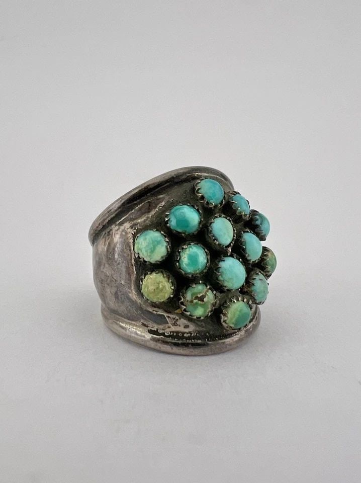 EARLY 1950'S NAVAJO INGOT SILVER & SNAKE EYE'S TURQUOISE CLUSTER WOMEN'S RING: EARLY 1950's NAVAJO INGOT SILVER & SNAKE EYE'S TURQUOISE CLUSTER WOMEN'S RING Ring Size: 4.5 - Can Be Resized Weight is 5.0 Grams on my scale Test Positive For At Least Coin Silver Ring is 3/4" Tall I