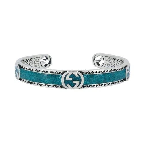 GUCCI STERLING SILVER ENAMEL INTERLOCKING G CUFF BRACELET: GUCCI STERLING SILVER ENAMEL INTERLOCKING G CUFF BRACELET KL AOO This Gucci sterling silver enamel cuff bracelet highlights the brand’s signature craftsmanship and bold design. The bracelet is craft