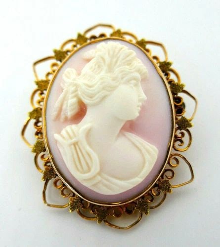 ANTIQUE CARVED ANGEL SKIN CORAL CAMEO 10K YELLOW GOLD PIN PENDANT: ANTIQUE CARVED ANGEL SKIN CORAL CAMEO 10K YELLOW GOLD PIN PENDANT Beautiful Antique carved angel skin coral cameo 10k yellow gold pin pendant Has a loop on top to be worn as a pendant Measurements: 1 