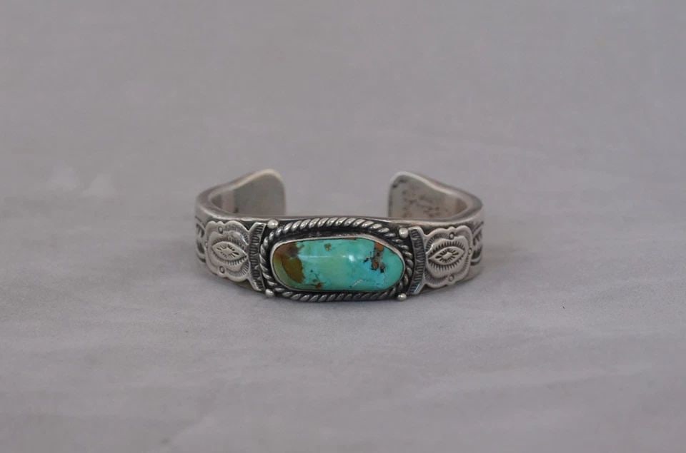 JOHN NELSON - VTG HEAVY NAVAJO HANDSTAMPED SILVER TURQUOISE BRACELET - 7" MENS: This vintage bracelet has been beautifully crafted by Navajo silversmith John Nelson. The sterling silver band is 1/8" thick. The bracelet weighs 124.5 grams or 4.4 ounces. The size is 5 7/8" around t
