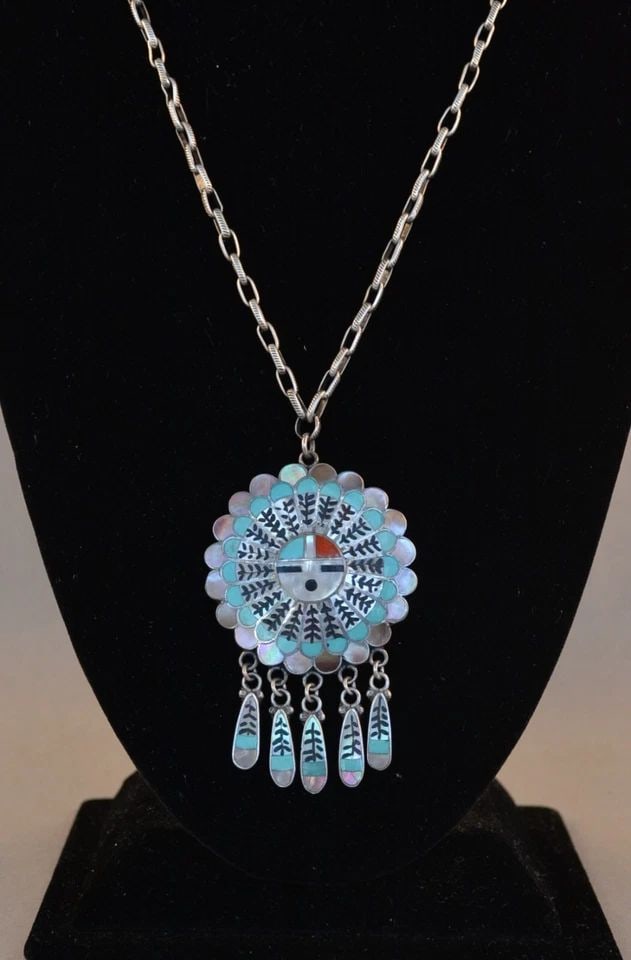 VINTAGE ZUNI SILVER 24.5" NECKLACE W. 3" SUN FACE PENDANT W. DANGLING FEATHERS: VINTAGE ZUNI SILVER 24.5" NECKLACE W. 3" SUN FACE PENDANT W. DANGLING FEATHERS This sterling silver pendant necklace has been beautifully crafted by Zuni artists Edward and Pablita Quam. The pendant h
