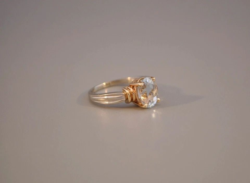 14K SOLID GOLD NATURAL LIGHT BLUE TOPAZ RING - GEMSTONE SOLITAIRE TWO TONE 7.75: 14K SOLID GOLD NATURAL LIGHT BLUE TOPAZ RING - GEMSTONE SOLITAIRE TWO TONE 7.75 This is a beautiful natural topaz ring. It weighs 5.72 grams. The front of the ring is 3/8" tall. The ring size is 7 3/4