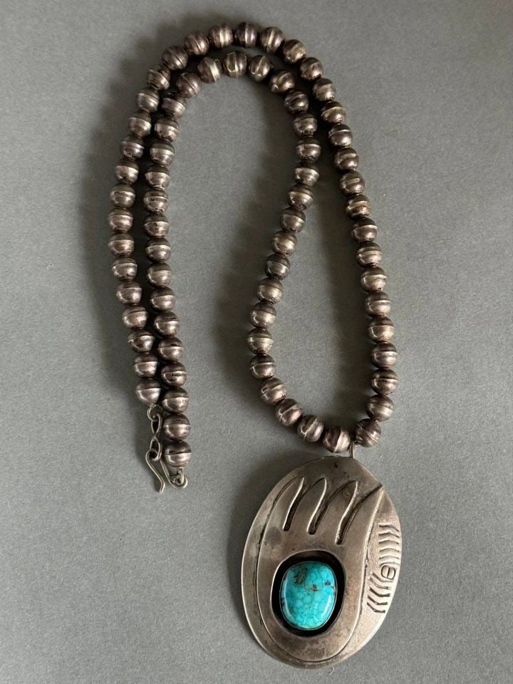 OLD PAWN NAVAJO STERLING SILVER NECKLACE. BEAR PAW PENDANT WITH TURQUOISE.: OLD PAWN NAVAJO STERLING SILVER NECKLACE. BEAR PAW PENDANT WITH TURQUOISE. Nice Necklace ..23 1/2 " Long with 1/4" bench press Sterling Beads ...Pendant Measures 2 5/8" Tall 1 3/4" Wide .. Signed DG W