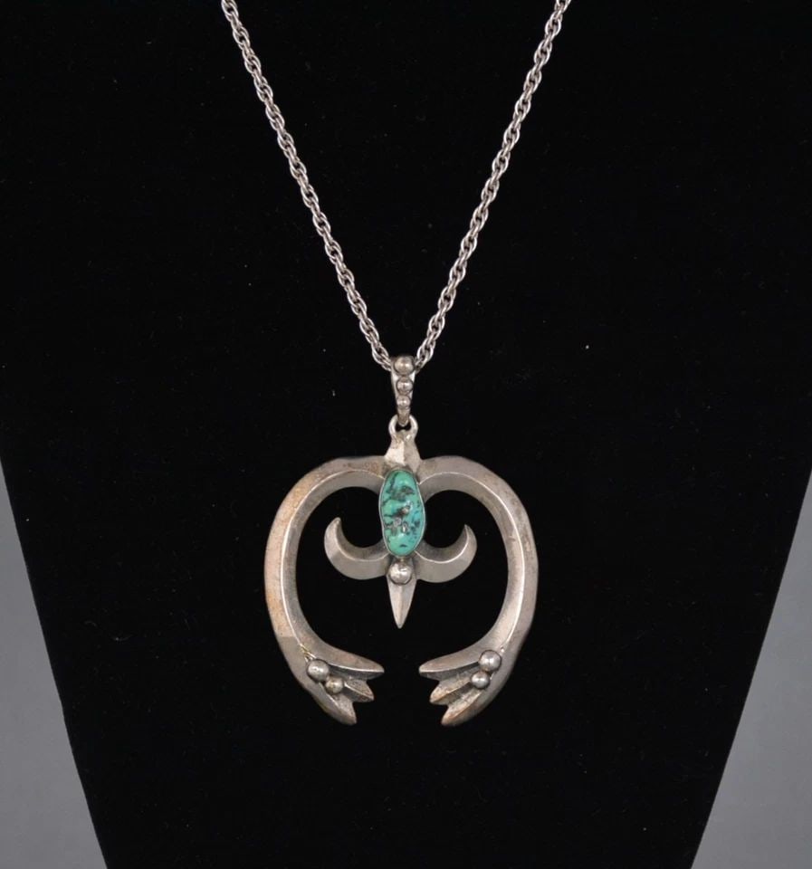 VINTAGE NAVAJO CAST STERLING SILVER NAJA PENDANT WITH TURQUOISE ON CHAIN: VINTAGE NAVAJO CAST STERLING SILVER NAJA PENDANT WITH TURQUOISE ON CHAIN This Navajo naja pendant has been beautifully cast in silver and set with a turquoise stone. It is on a 19.5" chain. The naja h