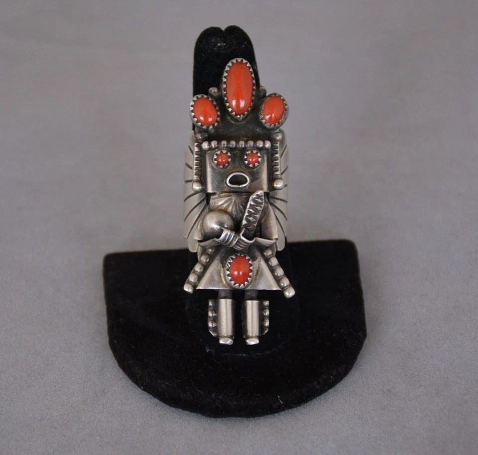 DORIS SMALLCANYON - STERLING SILVER KACHINA YEI RING - CORAL STONES - SIZE 7: This sterling silver ring has been beautifully crafted by Navajo silversmith Doris Smallcanyon. It is 2 1/4" tall and weighs 16.5 grams or .58 ounce. The ring is a size 7. It is signed with Doris's et