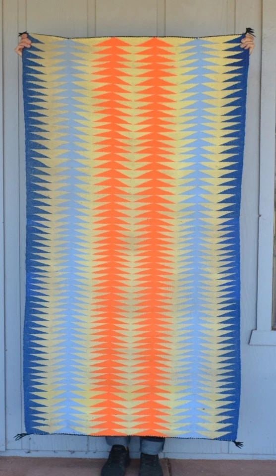 VINTAGE EYEDAZZLER NAVAJO RUG - NEON COLORS - ORANGE, YELLOW, BLUES - 61" X 33": This is an unusual eyedazzler Navajo rug which has been woven with commerical wool blends and colors. It measures 61" x 33". The condition is good - there are some dirt stains on both sides. The selva