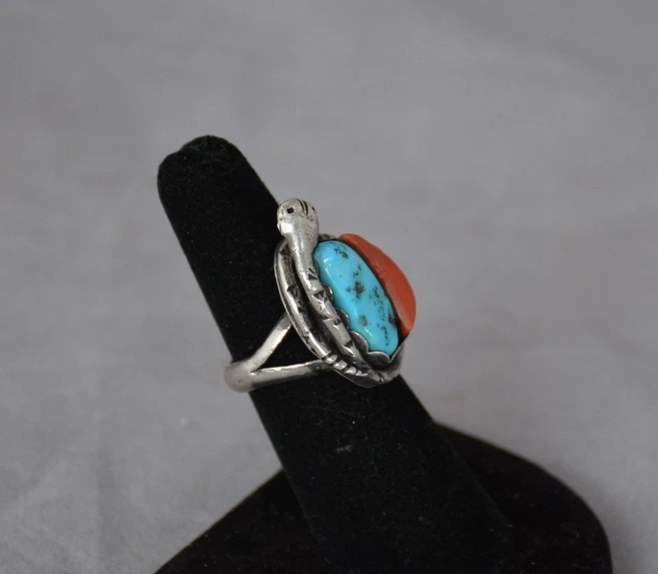 VINTAGE NAVAJO STERLING SILVER TURQUOISE CORAL RING W. SNAKE - SIZE 6: This vintage Navajo sterling silver ring has been beautifully crafted. A snake wraps around a nestled turquoise and coral stone. The front of the ring is 1 1/8" tall. The ring size is 6. Throughout th