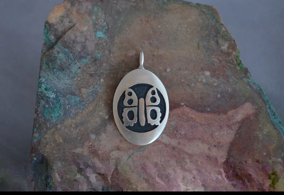 MANUEL HOYUNGOWA (1953-2011 - HOPI STERLING SILVER OVAL PENDANT BUTTERFLY - 1.5": MANUEL HOYUNGOWA (1953-2011 - HOPI STERLING SILVER OVAL PENDANT BUTTERFLY - 1.5" This sterling silver pendant has been beautifully crafted by the Hopi artists Manuel and Karen Hoyungwa. The pendant sh