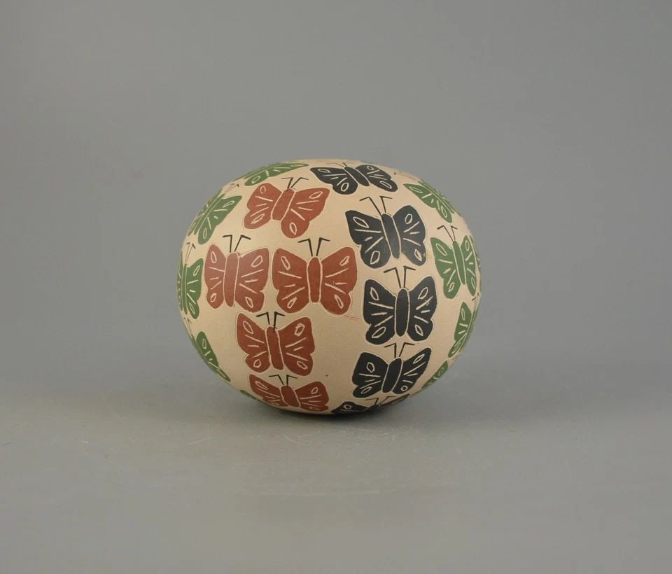 MATA ORTIZ SPHERICAL POT - COLORFUL BUTTERFLIES - ETCHED & HAND PAINTED: MATA ORTIZ SPHERICAL POT - COLORFUL BUTTERFLIES - ETCHED & HAND PAINTED This lovely butterfly pot was made by Mata Ortiz artist Raul Pedregon Bugarini. It measures 3" tall and 3 1/2" across. It is sig