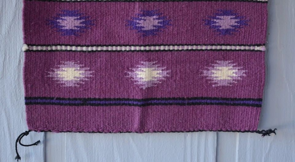 VINTAGE NAVAJO RUG - MAGNETA GROUND W WHITE LILAC PURPLE GEOMETRICS - 21" X 16": VINTAGE NAVAJO RUG - MAGNETA GROUND W WHITE LILAC PURPLE GEOMETRICS - 21" X 16" This vintage Navajo rug has a very unique color combination with serrated diamonds in a banded design. It measures 21" x