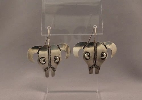 VINTAGE NAVAJO SILVER COW HEAD EARRINGS SIGNED YAZZIE: VINTAGE NAVAJO SILVER COW HEAD EARRINGS SIGNED YAZZIE Item Description: 1 3/4”Tall X 1 1/2” wide From top of wire to bottom of earring