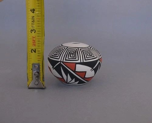 J. P. TORIVIO - SMALL SEED JAR POT - HANDPAINTED POLYCHROME DESIGNS - 2 1/8": J. P. TORIVIO - SMALL SEED JAR POT - HANDPAINTED POLYCHROME DESIGNS - 2 1/8" This small seed jar has been beautifully crafted by T. P. Torivio of the Acoma Pueblo. It is 2 1/8" tall and approximately 
