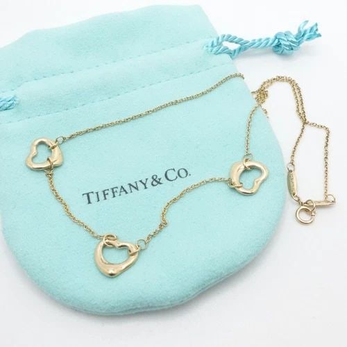 TIFFANY & CO. ELSA PERETTI 18K YELLOW GOLD OPEN HEART STATION NECKLACE 16.5": Tiffany & Co. Elsa Peretti 18K Yellow Gold Three Open Heart Station Necklace Length - 16.5" Long Chain Width - 1mm Pendant Width - 11mm Est. Retail Price - $1500 USD + Tax Total Weight - 4.9 Grams Hal