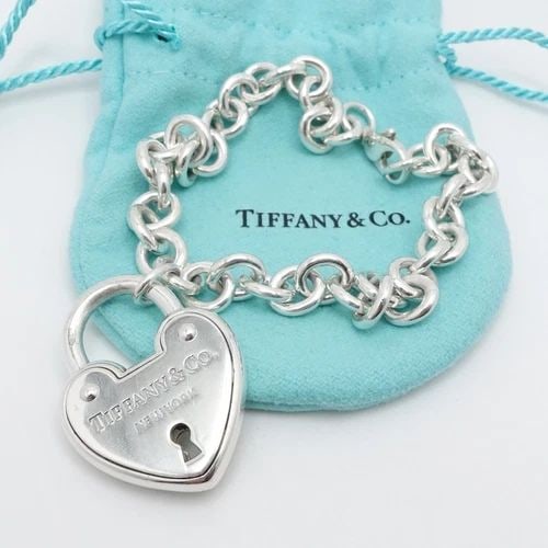 TIFFANY & CO. STERLING SILVER HEART PADLOCK CHAIN BRACELET SIZE 9" LONG POUCH: Tiffany & Co. Sterling Silver Large Heart Padlock Chain Bracelet Size - 9" Long Fits up to Relax 8" - 8.25" Snug Fit Chain Width - 8mm Charm Height - 1.33" Charm Width - 1" approx. Charm Depth - 5.5mm