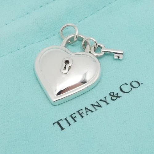 1994 TIFFANY & CO. STERLING SILVER HEART KEY PADLOCK PENDANT 1": Vintage 1994 Tiffany & Co. Sterling Silver Heart Key Padlock Pendant ONLY Height - 1" approx. Width - 0.86" Depth - 5.5mm Thick Bail Width - 5mm Total Weight - 13 Grams Hallmark - Tiffany & Co. 925 19