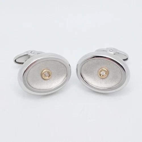 DOLAN BULLOCK STERLING SILVER & 14K GOLD BEZEL DIAMOND OVAL CUFFLINKS: Dolan Bullock Sterling Silver & 14K Yellow Gold Bezel Diamond Oval Cufflinks Height - 16mm Length - 21mm Total Weight - 17.2 Grams Hallmark - db 925 & 14K