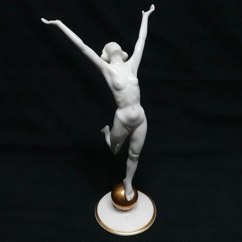 HUTSCHENREUTHER NUDE WOMAN STANDING ON GOLD BALL PORCELAIN FIGURINE - 8.5" TALL: HUTSCHENREUTHER NUDE WOMAN STANDING ON GOLD BALL PORCELAIN FIGURINE - 8.5" TALL Hutschenreuther Kunstabteilung Germany Nude Woman Standing On Gold Ball Art Deco Style Porcelain Figurine by Artist Karl