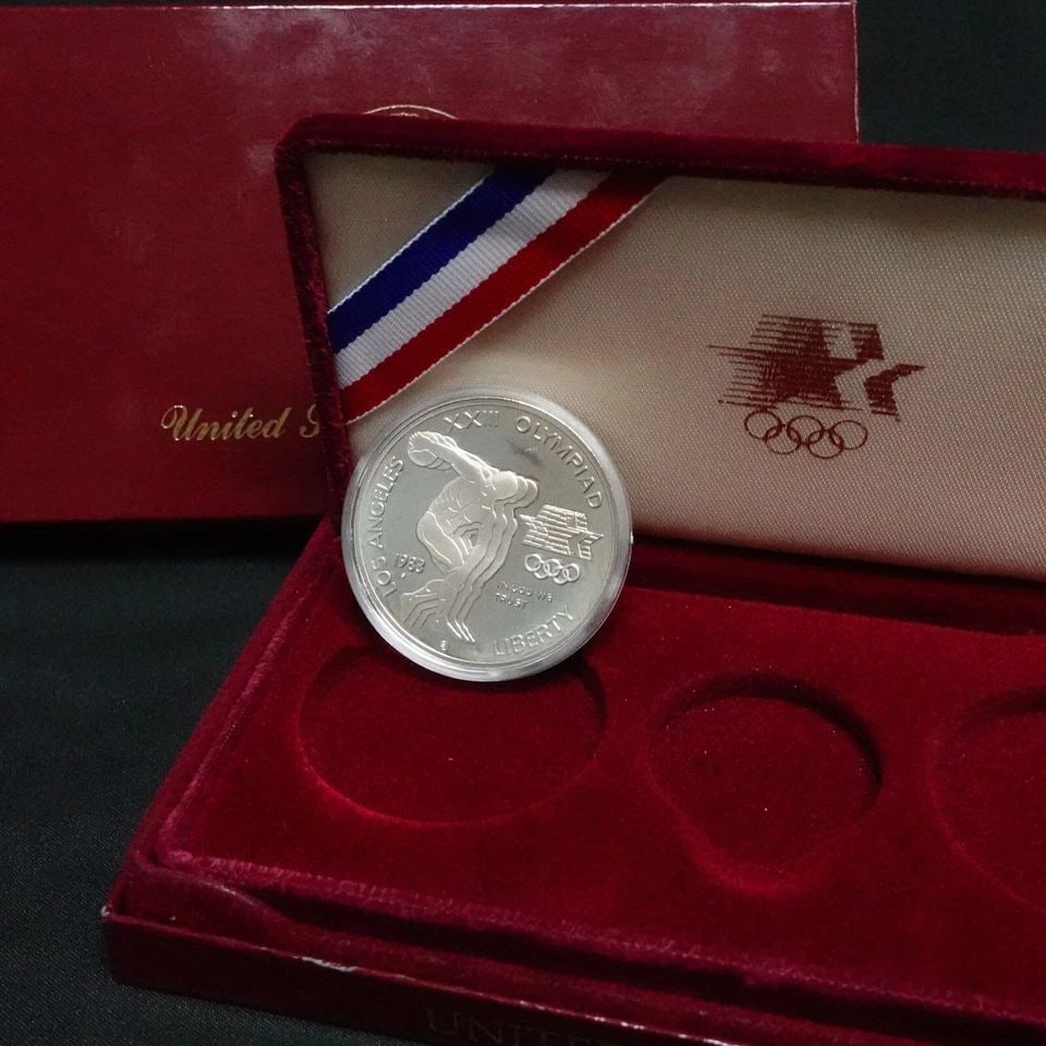 1983 S U.S MINT OLYMPIC SILVER PROOF $1 DOLLAR OGP & COA: 1983 S U.S MINT OLYMPIC SILVER PROOF $1 DOLLAR OGP & COA 1983 S U.S Mint Olympic Silver Proof $1 Dollar **Missing 1 Gold & 1 Silver Coin** OGP & Silver COA ONLY Included