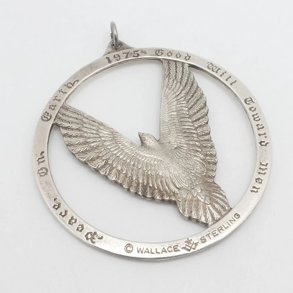 WALLACE STERLING SILVER DOVE ORNAMENT PEACE ON EARTH LARGE PENDANT 2.25": WALLACE STERLING SILVER DOVE ORNAMENT PEACE ON EARTH LARGE PENDANT 2.25" Wallace Sterling Silver Peace On Earth Dove Ornament Large Pendant Length - 2.25" Bail Height - 5mm Total Weight - 28.2 Grams