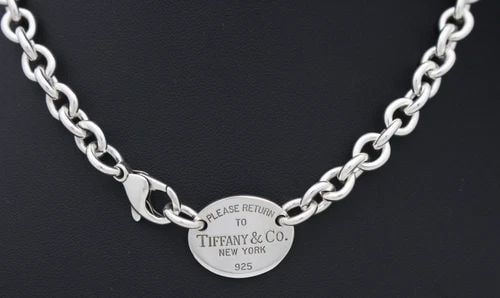TIFFANY & CO. STERLING SILVER PLEASE RETURN OVAL TAG NECKLACE 16" W/ POUCH: TIFFANY & CO. STERLING SILVER PLEASE RETURN OVAL TAG NECKLACE 16" W/ POUCH Description Tiffany & Co. Sterling Silver Please Return Oval Tag Choker Necklace Necklace is in good condition. May show sign