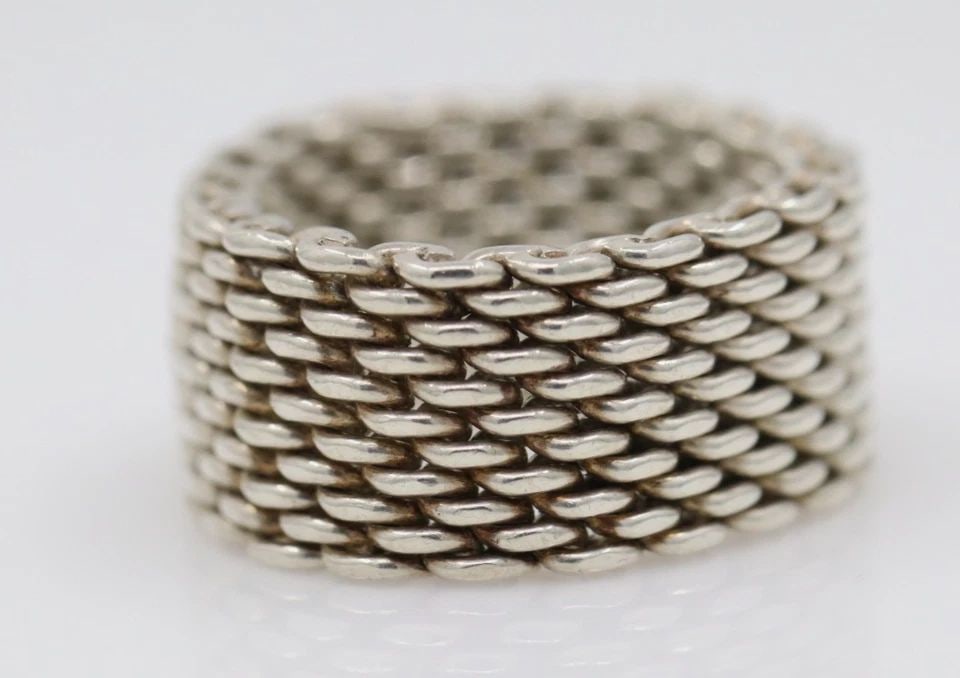 TIFFANY & CO. STERLING SILVER SOMERSET MESH 10MM BAND RING SIZE 8.5 - 9 GRAMS: TIFFANY & CO. STERLING SILVER SOMERSET MESH 10MM BAND RING SIZE 8.5 - 9 GRAMS Description Tiffany & Co. Sterling Silver Somerset Mesh 10mm Band Ring Ring is in good condition. May show signs of wear a