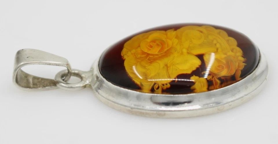 VINTAGE STERLING SILVER OVAL CARVED AMBER ROSE CAMEO PENDANT 2" ~ 13.6 GRAMS: VINTAGE STERLING SILVER OVAL CARVED AMBER ROSE CAMEO PENDANT 2" ~ 13.6 GRAMS Description Vintage Sterling Silver Oval Carved Amber Rose Cameo Pendant Pendant is in good condition. May show signs of we