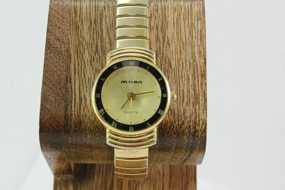 MILAN MLN1002 ROMAN NUMERAL BEZEL GOLD TONE STRETCH STAINLESS STEEL WATCH (1 of 1)