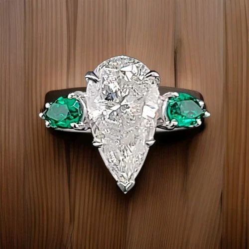 PLATINUM VINTAGE ENGAGEMENT RING 4.02CT.NATURAL PEAR SHAPE DIAMOND GREEN EMERALD: PLATINUM VINTAGE ENGAGEMENT RING 4.02CT. NATURAL PEAR SHAPE DIAMOND I1-I This stunning vintage platinum ring features a beautiful 4.02ct natural pear-shaped diamond, surrounded by two sparkling green 