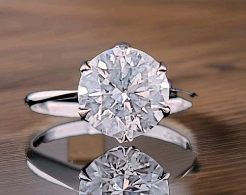 PLATINUM VINTAGE ENGAGEMENT RING 2.61CT. NATURAL ROUND DIAMOND CIRCA 1930'S: PLATINUM VINTAGE ENGAGEMENT RING 2.61CT. NATURAL ROUND DIAMOND CIRCA 1930'S This exquisite vintage Art Deco engagement ring is crafted in solid platinum and dates to the 1930s. It features a striking 