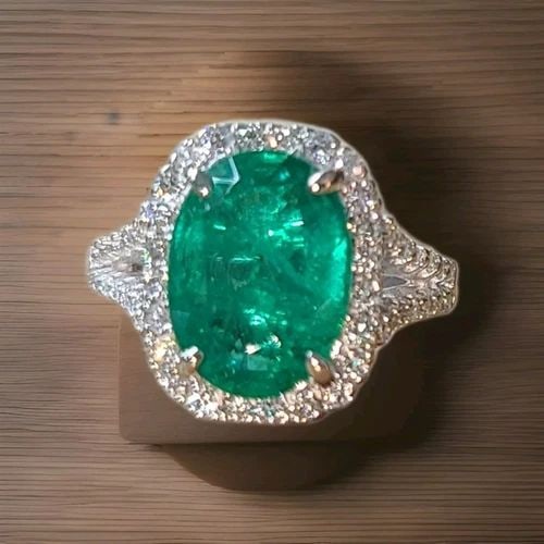 14K WHITE GOLD ENGAGEMENT RING 5.03CT NATURAL GREEN EMERALD OVAL SHAPE: This beautiful 14k white gold ring features a stunning 5.03ct natural green emerald in an oval shape. The gemstone is treated with oil and has a clarity grade eye clean, making it a high-quality piece