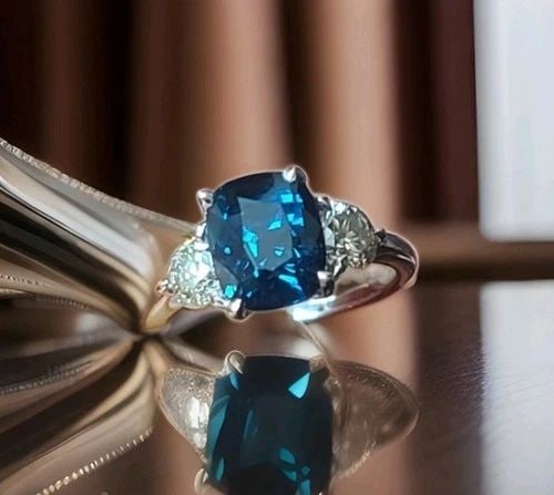 14K WHITE GOLD ENGAGEMENT RING 4.04CT.NATURAL NO HEAT BLUE SAPPHIRE CUSHION GIA: 14K WHITE GOLD ENGAGEMENT RING 4.04CT.NATURAL NO HEAT BLUE SAPPHIRE CUSHION GIA This elegant engagement ring is crafted in solid 14K white gold and showcases a stunning natural teal blue sapphire in a