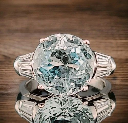 VINTAGE PLATINUM ENGAGEMENT RING 6.67CT. NATURAL SKY BLUE AQUAMARINE ROUND CUT: VINTAGE PLATINUM ENGAGEMENT RING 6.67CT. NATURAL SKY BLUE AQUAMARINE ROUND CUT The Vintage Platinum Engagement Ring features a stunning 6.67ct natural sky blue aquamarine with a round cut. This unique