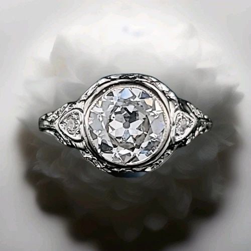 14K WHITE GOLD FILIGREE ENGAGEMENT RING 1.65CT. LAB GROWN OLD EURO CUT DIAMOND: 14K WHITE GOLD FILIGREE ENGAGEMENT RING 1.65CT. LAB GROWN OLD EURO CUT DIAMOND This 14k white gold Filigree Engagement Ring features a 1.65ct lab grown Old Euro Cut Diamond as the main stone. The vint