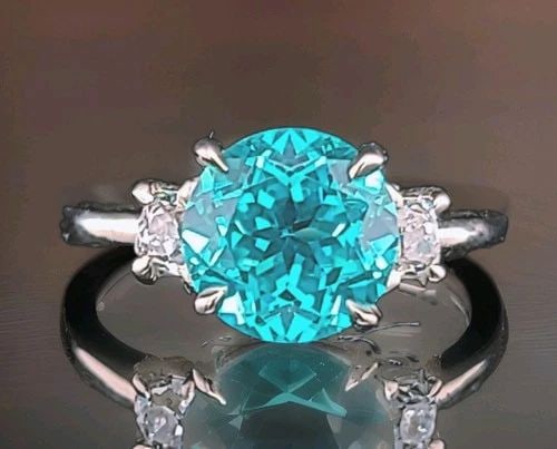 VINTAGE 14K WHITE GOLD ENGAGEMENT RING 4.10CT. BLUE NEON TOURMALINE ROUND SHAPE: VINTAGE 14K WHITE GOLD ENGAGEMENT RING 4.10CT. BLUE NEON TOURMALINE ROUND SHAPE This gorgeous vintage engagement ring is crafted in luxurious 14K white gold and showcases a breathtaking round lab-grow