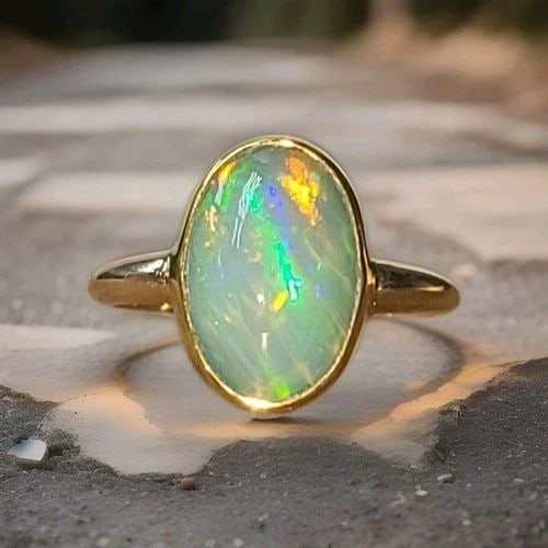 VINTAGE 14K-22K YELLOW GOLD 4.25CT. NATURAL AFRICA OPAL ENGAGEMENT BEZEL RING: VINTAGE 14K-22K YELLOW GOLD 4.25CT. NATURAL AFRICA OPAL ENGAGEMENT BEZEL RING There is something almost mystical about an opal… A stone that carries a rainbow within it. This enchanting vintage ring