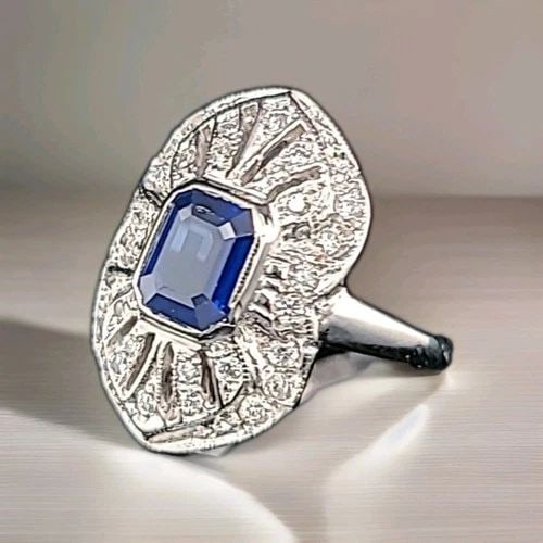 VINTAGE 14K WHITE GOLD EMERALD CUT NATURAL BLUE SAPPHIRE ENGAGEMENT RING 1.57CT.: VINTAGE 14K WHITE GOLD RING 1.57CT. NATURAL BLUE SAPPHIRE EMERALD CUT CIRC 1950' This beautiful vintage ring is crafted from 14k white gold and features a stunning 1.57CT natural blue sapphire with an
