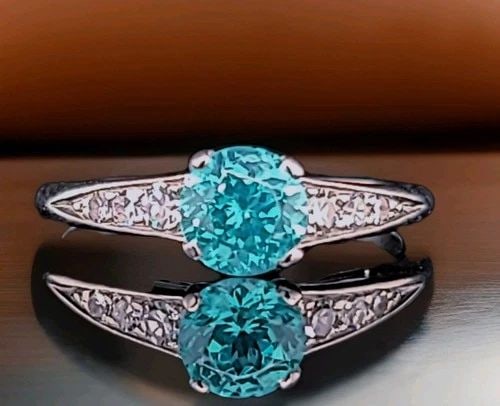 VINTAGE PLATINUM ENGAGEMENT RING 1.30CT. BLUE TOURMALINE ROUND SHAPE: VINTAGE PLATINUM ENGAGEMENT RING 1.30CT. BLUE TOURMALINE ROUND SHAPE This stunning vintage ring features a Round-cut lab-grown blue tourmaline with a vibrant neon blue color, center weighing 1.30 ct a