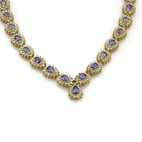 TANZANITE & DIAMOND GOLD NECKLACE 14K YELLOW V COLLAR STYLE: TANZANITE & DIAMOND GOLD NECKLACE 14K YELLOW V COLLAR STYLE This is a gorgeous Estate necklace; it is crafted from 14k yellow gold featuring 37 pear shape tanzanite mounted in the center of pear shape