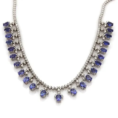 DIAMOND GOLD NECKLACE TANZANITE 18K WHITE BIB STYLE: DIAMOND GOLD NECKLACE TANZANITE 18K WHITE BIB STYLE The Diamond & Tanzanite Gold Necklace is a stunning piece of fine jewelry featuring a white diamond with a very good cut grade set in 18k white gold