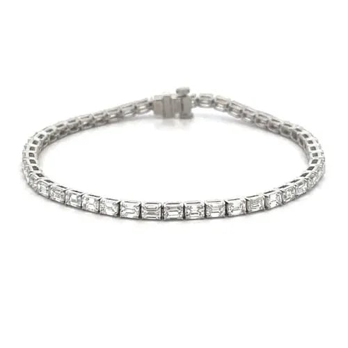 EMERALD CUT TENNIS BRACELET 6.80CT 18K WHITE GOLD NEW: EMERALD CUT TENNIS BRACELET 6.80CT 18K WHITE GOLD NEW This is an eye-catching NEW line tennis bracelet. It is crafted from 18k white gold with a polished finish featuring the entire length of the brac