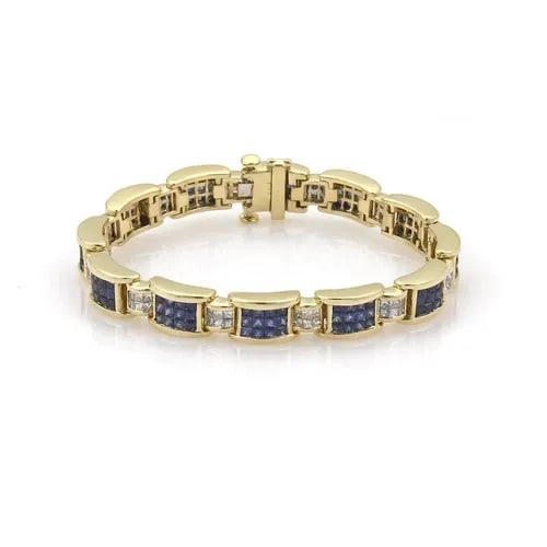 DIAMOND & SAPPHIRE BRACELET IN 18K YELLOW GOLD PRINCESS CUT INVISIBLY SET: DIAMOND & SAPPHIRE BRACELET IN 18K YELLOW GOLD PRINCESS CUT INVISIBLY SET 18k Yellow Gold Princess Cut Diamond & Sapphire Invisibly Set Bracelet Description This magnificent bracelet is crafted from 1