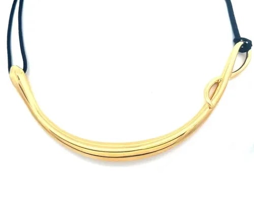 TIFFANY & CO. GOLD SNAKE PENDANT PERETTI 18K YELLOW BLACK CORD PAPER: TIFFANY & CO. GOLD SNAKE PENDANT PERETTI 18K YELLOW BLACK CORD PAPER This is an eye-catching authentic early edition collar necklace from Tiffany & Co., by designer Elsa Peretti, this particular desig