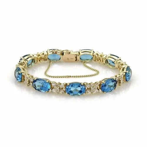 BLUE TOPAZ DIAMOND GOLD BRACELET 14K YELLOW OVAL STAR LINK STYLE ESTATE: BLUE TOPAZ DIAMOND GOLD BRACELET 14K YELLOW OVAL STAR LINK STYLE ESTATE This gorgeous diamond and blue topaz bracelet feature a stunning oval and star link style in 14k yellow gold. The bracelet showc