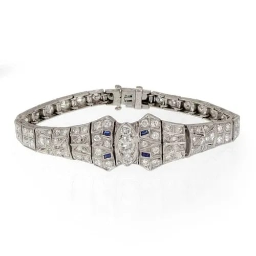 DIAMOND PLATINUM BRACELET TAPERED MILGRAIN DESIGN ART DECO: DIAMOND PLATINUM BRACELET TAPERED MILGRAIN DESIGN ART DECO This Diamond Platinum Bracelet features a tapered milgrain design in an Art Deco style. The vintage piece is adorned with blue gemstones and 