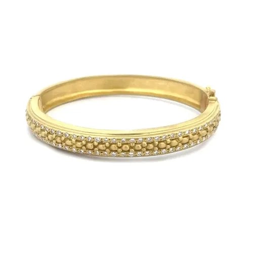 DORIS PANOS DIAMOND GOLD BRACELE 18K YELLOW HINGED BEAD STYLE ANGLE: DORIS PANOS DIAMOND GOLD BRACELE 18K YELLOW HINGED BEAD STYLE ANGLE This lovely authentic bracelet is crafted from 18k yellow gold in a satin finish featuring an oval shape grooved band. It is hinged 