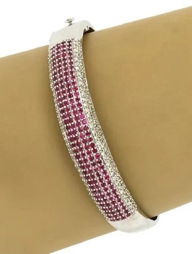 DIAMOND PINK SAPPHIRE BRACELET GOLD 14K WHITE BANGLE: DIAMOND PINK SAPPHIRE BRACELET GOLD 14K WHITE BANGLE This Diamond Pink Sapphire Bracelet in 14k White Gold is a stunning piece of fine jewelry. The round cut diamonds and pink sapphire secondary stone